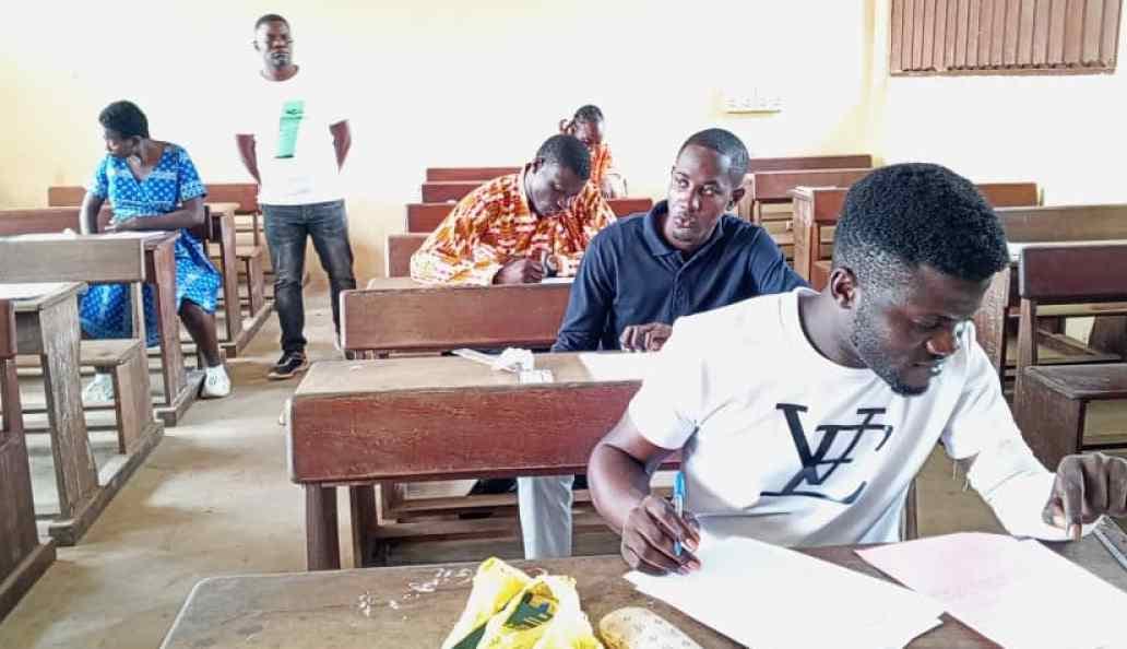 Candidats au baccalauréat assis dans une salle d'examen, en train de composer