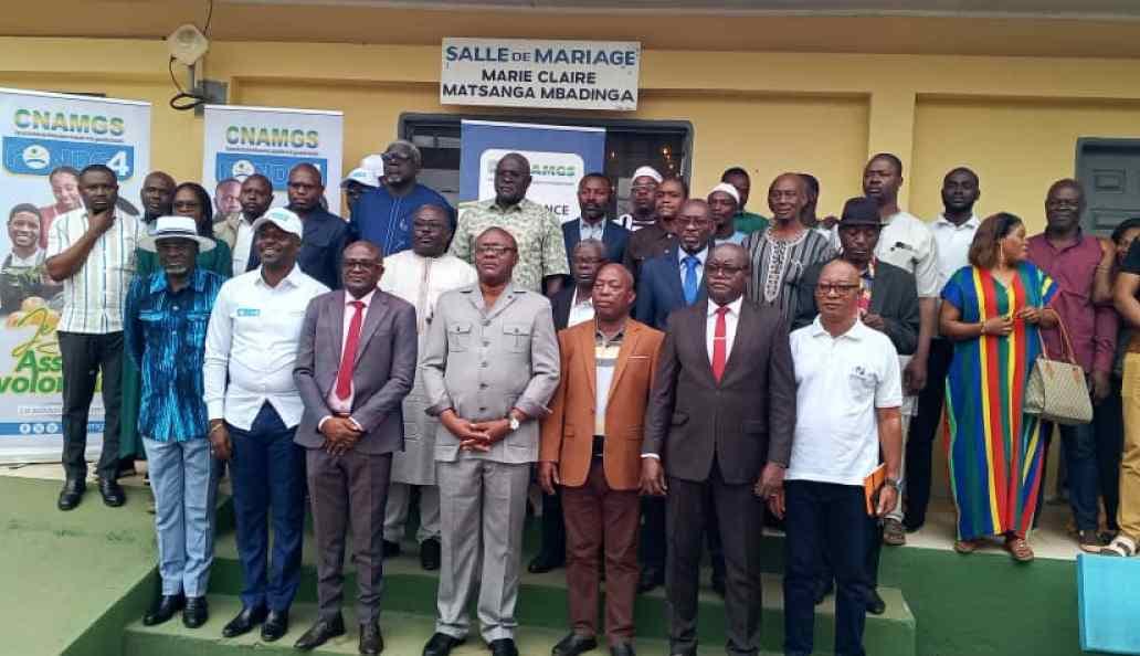 Réunion de sensibilisation de la CNAMGS à Tchibanga avec des travailleurs indépendants assis face à un intervenant