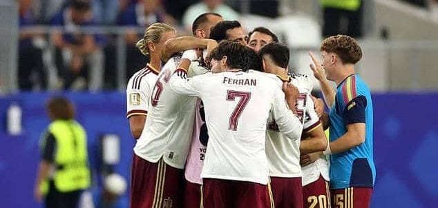 Joueurs de l'équipe d'Espagne de football célébrant une victoire sur un terrain de stade éclairé