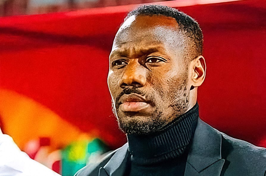 Sélectionneur de football sénégalais sur le banc de touche pendant un match