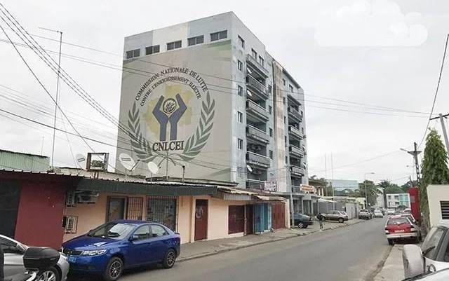 Salle de conférence institutionnelle avec drapeaux gabonais