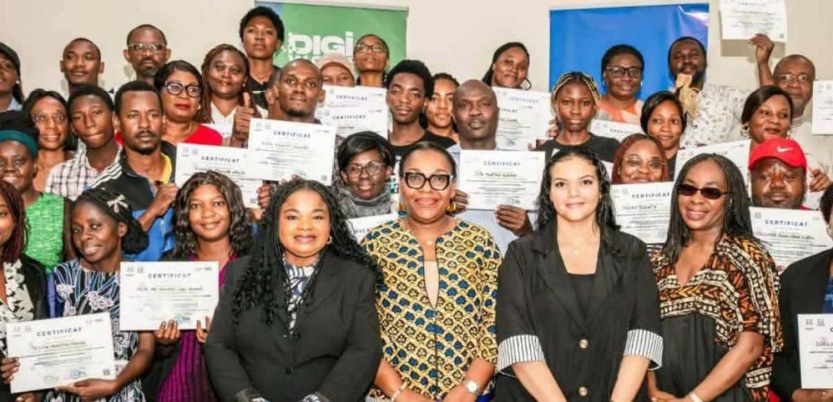 Apprenants suivant une formation informatique dans une salle de classe équipée d'ordinateurs