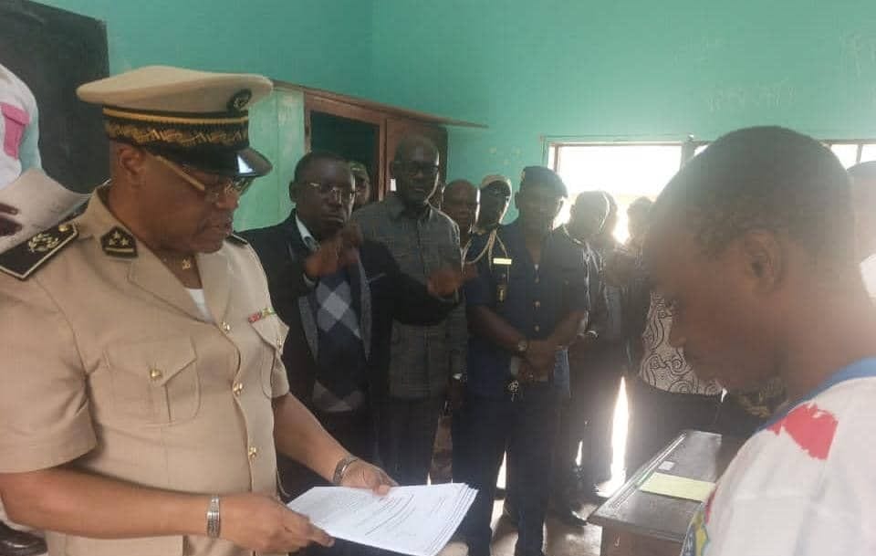 Salle d'examen de baccalauréat dans un lycée provincial du Gabon avec des élèves composant